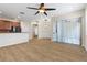 Spacious living area with modern flooring, a ceiling fan, and sliding glass doors leading to outdoor area at 1062 Wickerwood St, Ocoee, FL 34761
