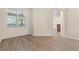 Bright living area featuring modern floors, a large window for natural light, and a neutral color palette at 1062 Wickerwood St, Ocoee, FL 34761
