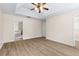 Large main bedroom boasts wood-look flooring and a tray ceiling at 1062 Wickerwood St, Ocoee, FL 34761