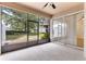Screened patio with ceiling fan, and view of landscaped backyard at 1062 Wickerwood St, Ocoee, FL 34761