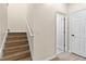 Staircase with wood steps and handrail leading to the upper level at 1062 Wickerwood St, Ocoee, FL 34761