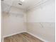 Organized walk-in closet with wire shelving and wood-look floors at 1062 Wickerwood St, Ocoee, FL 34761