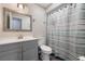 Stylish bathroom featuring a well-lit vanity and a shower with an attractive striped curtain at 1198 E Hancock Dr, Deltona, FL 32725