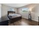 Serene bedroom with hardwood floors, neutral walls, two windows, and a comfortable queen-sized bed at 1198 E Hancock Dr, Deltona, FL 32725