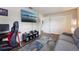 Comfortable bedroom featuring a sofa, large TV, and a view into the hallway with white closet doors at 1198 E Hancock Dr, Deltona, FL 32725