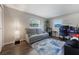 Bright bedroom with cozy gray sofa and a colorful accent rug, illuminated by natural light from two windows at 1198 E Hancock Dr, Deltona, FL 32725