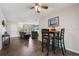 Cozy dining area featuring hardwood floors, a stylish pub-height table with chairs, and easy access to the living room at 1198 E Hancock Dr, Deltona, FL 32725