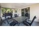 Inviting screened-in patio featuring an outdoor dining set and grill for entertaining guests at 1198 E Hancock Dr, Deltona, FL 32725