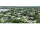 Aerial view showcases a neighborhood surrounded by mature trees and a lake at 1271 Old Mill Rd, Orlando, FL 32806