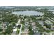 An aerial view of a lakeside neighborhood, complete with mature trees and a tranquil lake at 1271 Old Mill Rd, Orlando, FL 32806