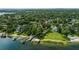 Stunning aerial of a waterfront property with a private dock and lush greenery at 1271 Old Mill Rd, Orlando, FL 32806