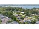 An aerial view highlights a property with a manicured lawn, mature trees, and neighborhood pool at 1271 Old Mill Rd, Orlando, FL 32806