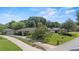 Aerial view of a well-maintained home with a spacious front lawn and separate garage at 1271 Old Mill Rd, Orlando, FL 32806