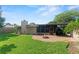 Grassy backyard with patio and outdoor fireplace at 1271 Old Mill Rd, Orlando, FL 32806