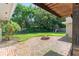 Landscaped backyard with brick patio, fire pit, and play structure at 1271 Old Mill Rd, Orlando, FL 32806