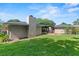 Large backyard features patio, lawn, and mature trees at 1271 Old Mill Rd, Orlando, FL 32806