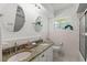 Bathroom with dual sinks, granite countertops, and tile flooring, offering both style and functionality at 1271 Old Mill Rd, Orlando, FL 32806