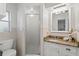 Bright bathroom featuring a shower with glass doors, granite countertops and white cabinets at 1271 Old Mill Rd, Orlando, FL 32806