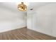 Bedroom with wood laminate flooring, a ceiling fan, and a double door closet at 1271 Old Mill Rd, Orlando, FL 32806