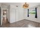 Spacious bedroom featuring luxury vinyl plank flooring, natural light, and a double door closet at 1271 Old Mill Rd, Orlando, FL 32806