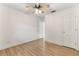This bedroom is empty, but has wood laminate flooring, and ceiling fan at 1271 Old Mill Rd, Orlando, FL 32806