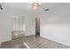 Minimalist bedroom with mirrored closet, luxury vinyl plank flooring, and a bright, airy feel at 1271 Old Mill Rd, Orlando, FL 32806