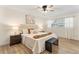 This bedroom is designed with wood floors, a stylish bench, and a soothing neutral palette at 1271 Old Mill Rd, Orlando, FL 32806