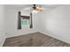 Bedroom features wood-look floors, a window with curtains, and light-colored walls at 1271 Old Mill Rd, Orlando, FL 32806