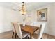 Bright dining room with hardwood floors, modern wainscoting, and a beaded chandelier at 1271 Old Mill Rd, Orlando, FL 32806