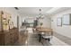 This open dining room has modern furniture and a seamless view into the updated kitchen at 1271 Old Mill Rd, Orlando, FL 32806