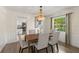 This dining room features wood floors, wainscoting, and views of the yard and kitchen at 1271 Old Mill Rd, Orlando, FL 32806