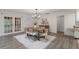 Light and open dining room with wood floors, stylish furniture, and doors to a patio at 1271 Old Mill Rd, Orlando, FL 32806