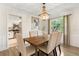 Dining room with hardwood floors and an ornate chandelier adjacent to the kitchen at 1271 Old Mill Rd, Orlando, FL 32806