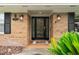 Inviting front entrance featuring a decorative glass door, stylish lighting fixtures, and a well-kept brick facade at 1271 Old Mill Rd, Orlando, FL 32806