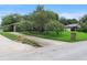 A well-maintained home showcasing a spacious driveway, mature tree, and neatly landscaped front yard at 1271 Old Mill Rd, Orlando, FL 32806
