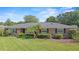Charming brick home featuring a well-manicured lawn and mature landscaping at 1271 Old Mill Rd, Orlando, FL 32806