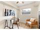 Home office boasts a glass desk, accent chair, modern art, and decorative patterned floor at 1271 Old Mill Rd, Orlando, FL 32806