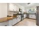 Well-lit kitchen featuring granite countertops, stainless steel appliances, and white subway tile backsplash at 1271 Old Mill Rd, Orlando, FL 32806