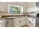 The kitchen has white cabinets, black hardware, granite counters, and stainless steel appliances at 1271 Old Mill Rd, Orlando, FL 32806