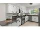 Bright kitchen features stainless appliances, white cabinets and subway tile backsplash at 1271 Old Mill Rd, Orlando, FL 32806