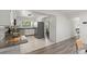 Spacious kitchen with white cabinets, stainless steel appliances, and a large window for ample natural light at 1271 Old Mill Rd, Orlando, FL 32806