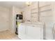 Laundry room view features tiled floors, washer, dryer, water heater and shelf at 1271 Old Mill Rd, Orlando, FL 32806