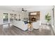 Living room with gray hardwood floors, modern furniture, fireplace, and access to outdoor patio at 1271 Old Mill Rd, Orlando, FL 32806