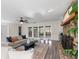 A large living room shows modern furniture, hardwood flooring, and access to the outdoor patio at 1271 Old Mill Rd, Orlando, FL 32806