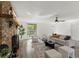 Cozy living room with a brick fireplace, plush seating, and a view to the outdoors at 1271 Old Mill Rd, Orlando, FL 32806
