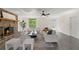 Bright living room with a brick fireplace, ceiling fan, hardwood flooring, and neutral furniture at 1271 Old Mill Rd, Orlando, FL 32806