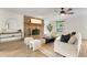 Cozy living room featuring a brick fireplace, hardwood floors, and a ceiling fan at 1271 Old Mill Rd, Orlando, FL 32806