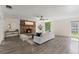 Spacious living room features a cozy brick fireplace and stylish decor, great for relaxation and gatherings at 1271 Old Mill Rd, Orlando, FL 32806