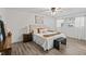Bright primary bedroom with natural light, hardwood flooring, ceiling fan, and neutral paint scheme at 1271 Old Mill Rd, Orlando, FL 32806