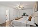 Primary bedroom with hardwood floors, a ceiling fan, and access to the primary bathroom at 1271 Old Mill Rd, Orlando, FL 32806
